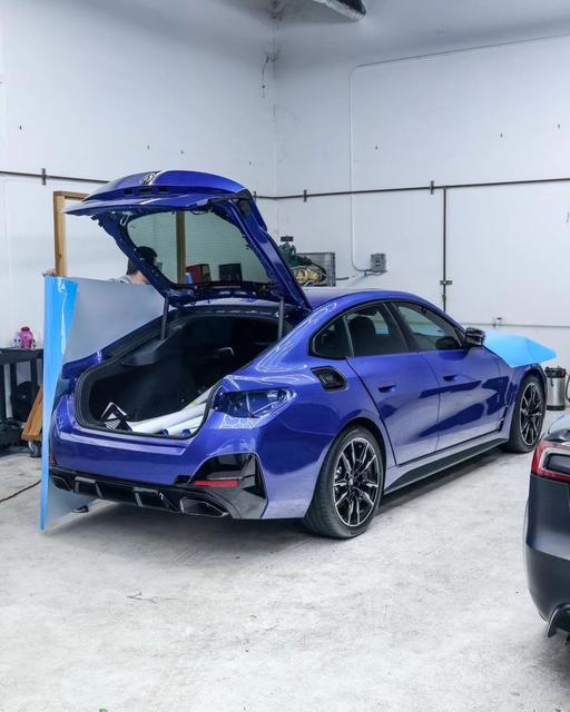 Blue BMW i4 with film being fitted in the 68 Auto Film shop