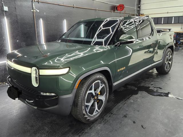 Dark green Rivian R1T in the 68 Auto Film bay